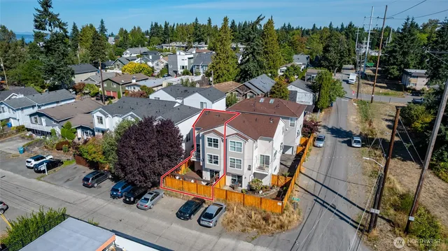 an aerial view of a house with a swimming pool and outdoor seating
