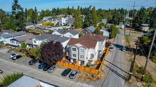 an aerial view of a house with a swimming pool and outdoor seating