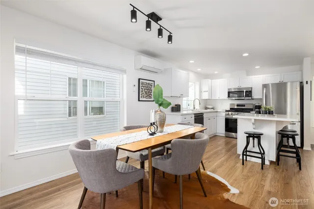 a view of a dining room with furniture and wooden floor