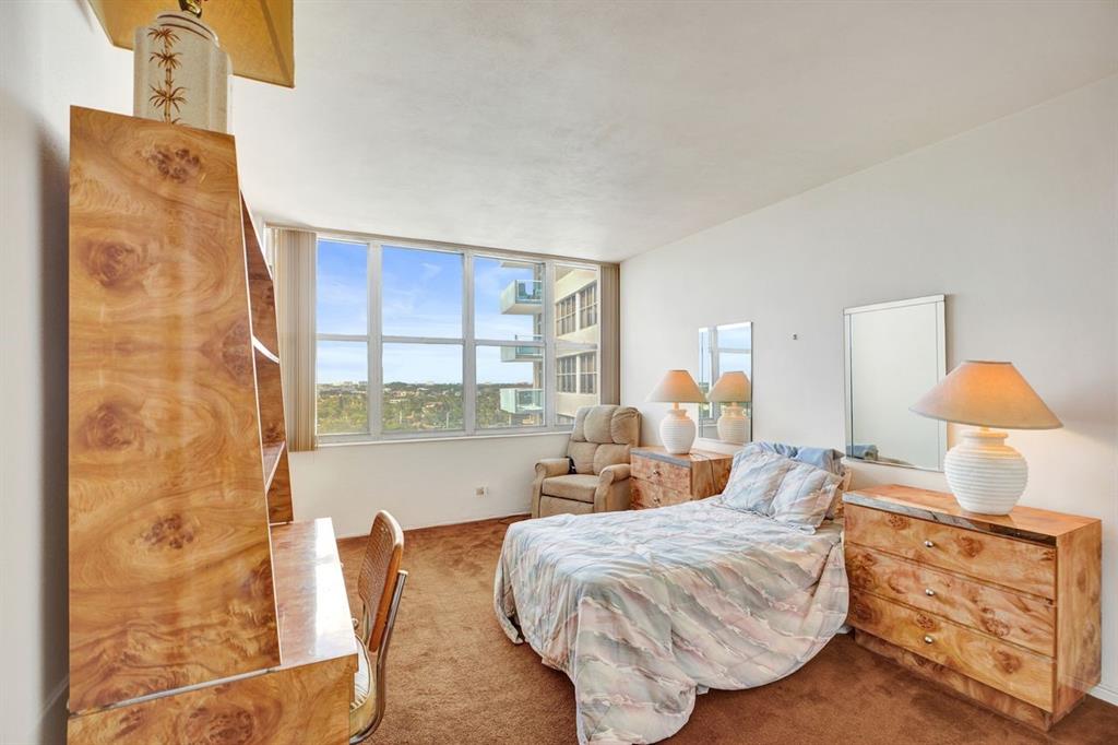 7441 Wayne Avenue, Unit 10C Miami Beach, FL 33141 - Photo 22 of 86 a living room with furniture and a lamp