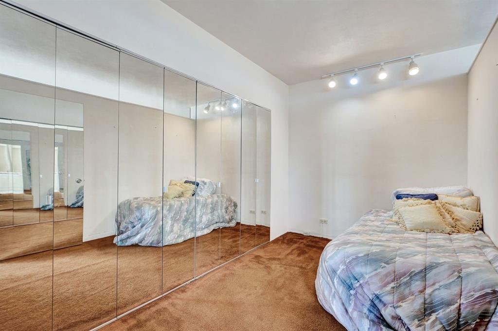 7441 Wayne Avenue, Unit 10C Miami Beach, FL 33141 - Photo 26 of 86 a bedroom with a bed and a mirror