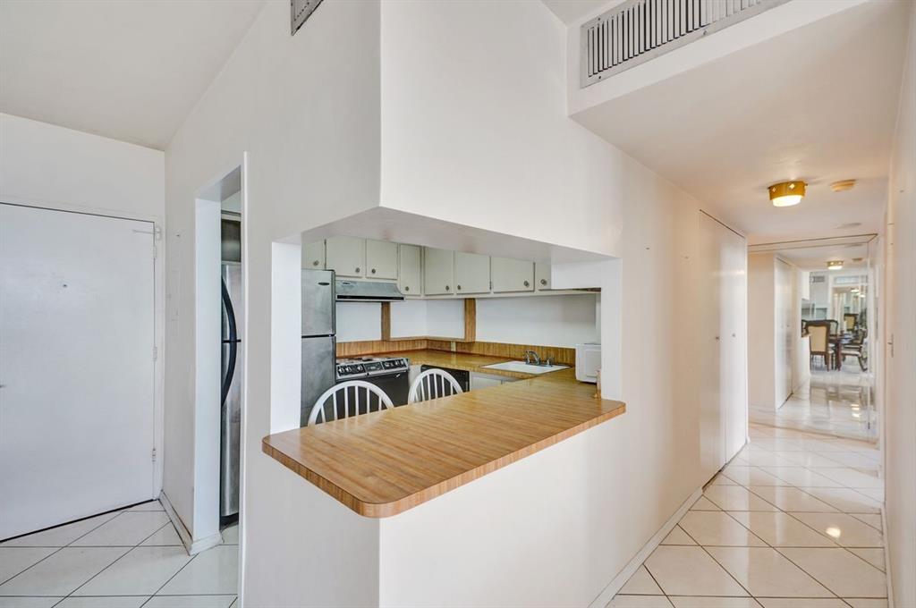 7441 Wayne Avenue, Unit 10C Miami Beach, FL 33141 - Photo 33 of 86 a kitchen with stainless steel appliances granite countertop a sink and a refrigerator