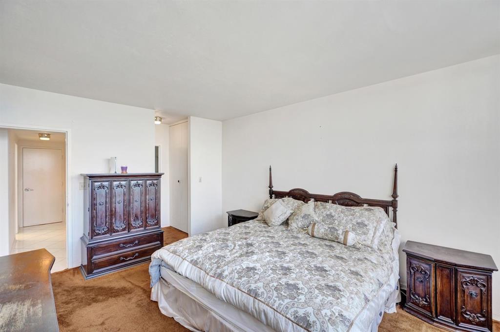 7441 Wayne Avenue, Unit 10C Miami Beach, FL 33141 - Photo 37 of 86 a bedroom with a bed and wooden floor