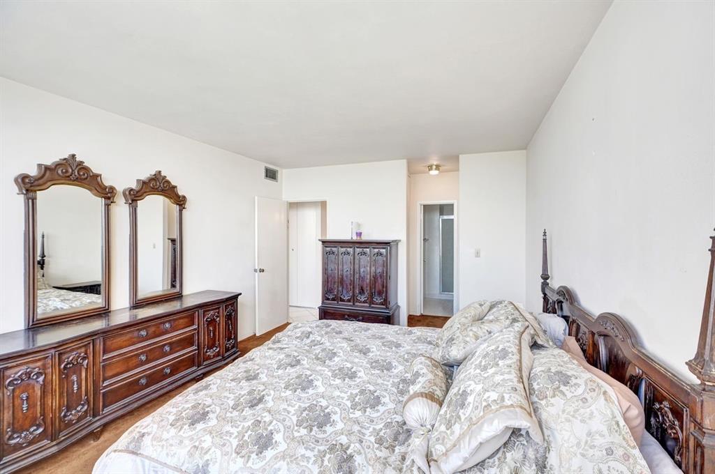 7441 Wayne Avenue, Unit 10C Miami Beach, FL 33141 - Photo 38 of 86 a bedroom with a bed and a large mirror on the dresser