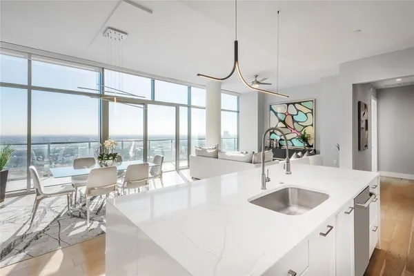 a very nice looking living room with a large window and chandelier