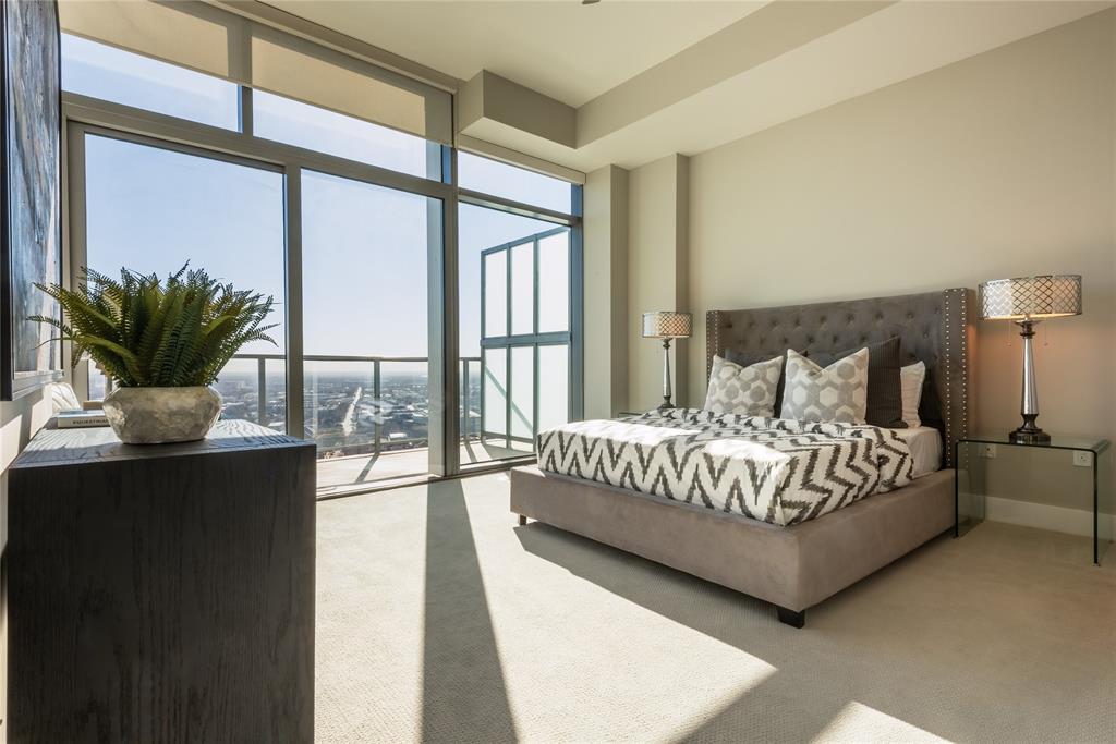 3031 Oliver Street, Unit 2007 Dallas, TX 75205 - Photo 13 of 29 a bedroom with a large bed and a potted plant