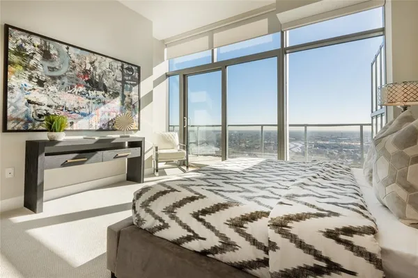a bedroom with a bed and a painting on the wall