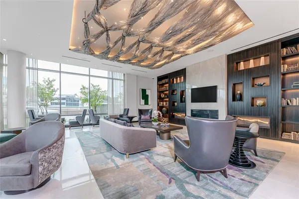 a living room with furniture a flat screen tv and a large window