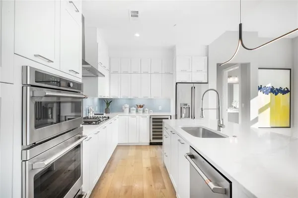 a kitchen with a sink stove and oven