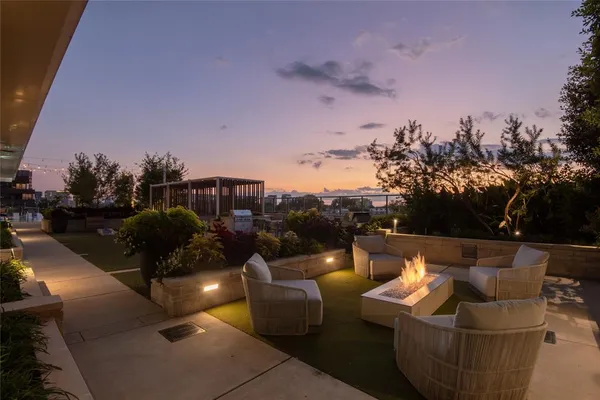 a view of a terrace with couches and sky view