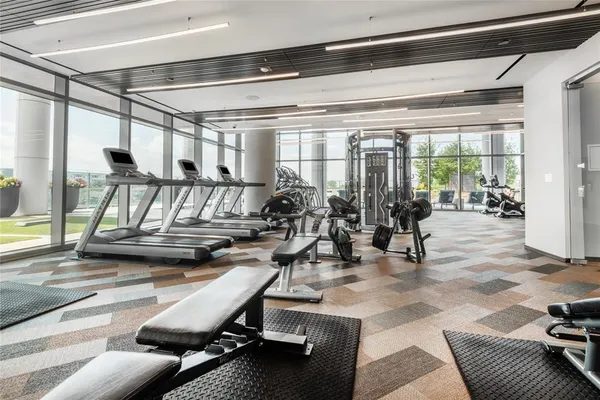 a view of a livingroom with furniture and floor to ceiling window
