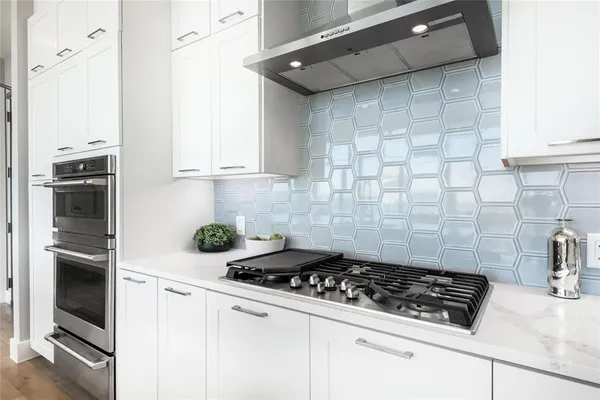a stove top oven sitting inside of a kitchen