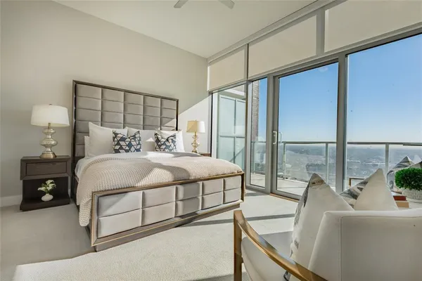 a bedroom with a bed and a large window