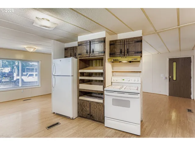 a kitchen with stainless steel appliances a refrigerator and a stove