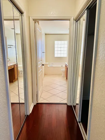 a view of a hallway with wooden floor