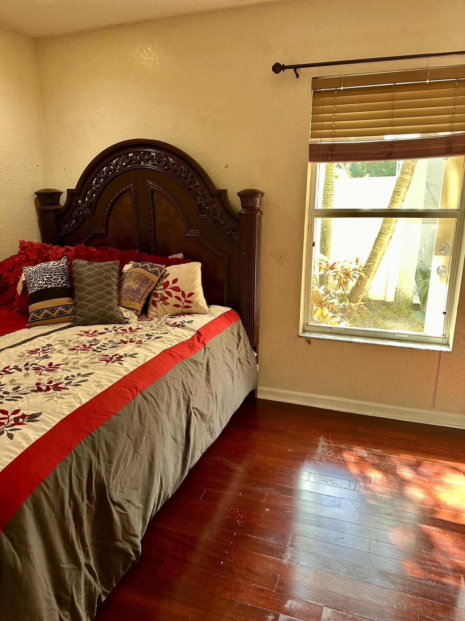 5200 Rising Comet Lane Greenacres, FL 33463 - Photo 27 of 50 a bedroom with a bed and a window