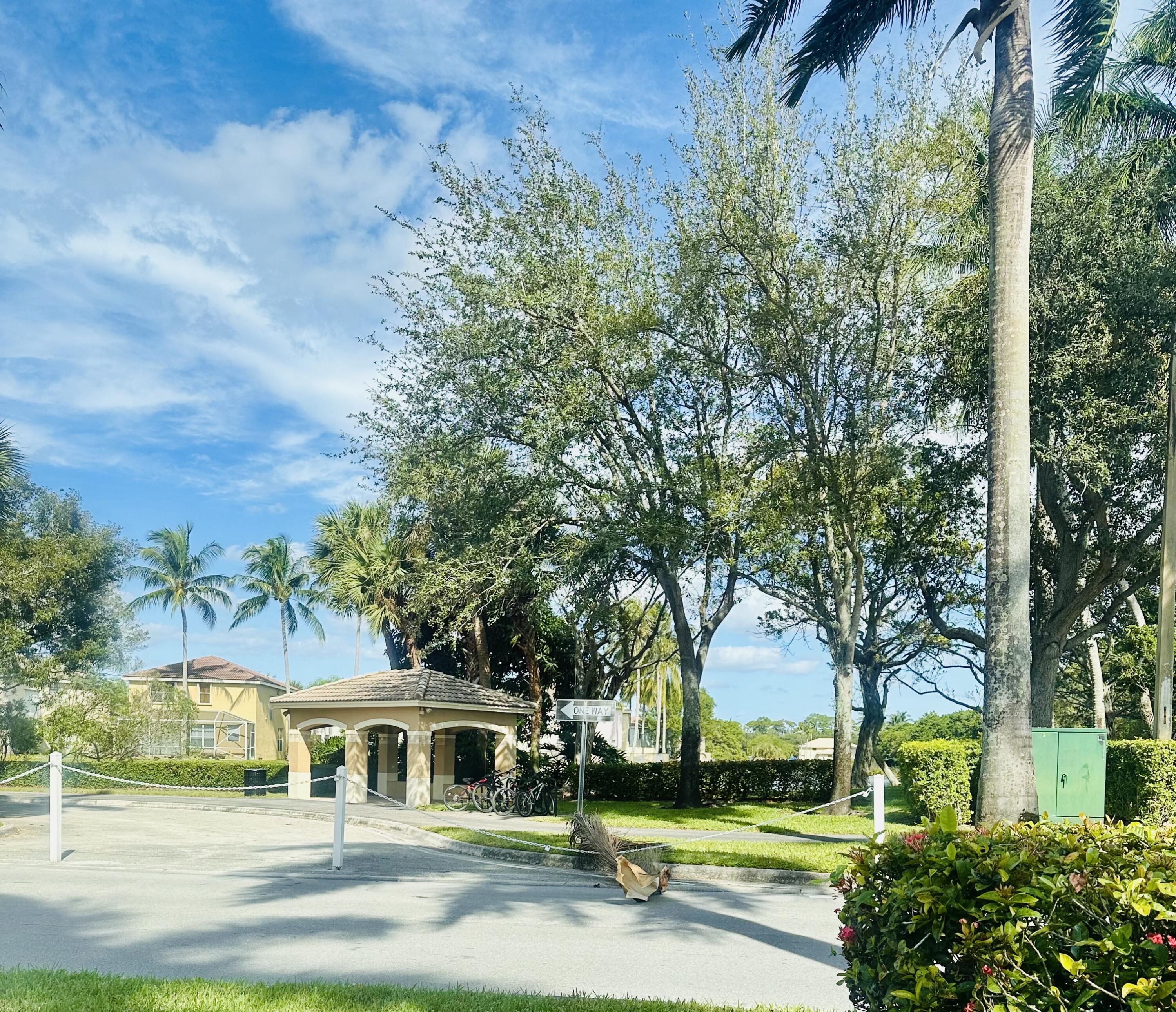 5200 Rising Comet Lane Greenacres, FL 33463 - Photo 41 of 50 a view of swimming pool and trees in the background