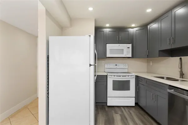 a kitchen with a refrigerator sink and stove