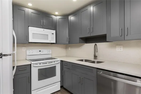 a kitchen with a sink and a stove top oven