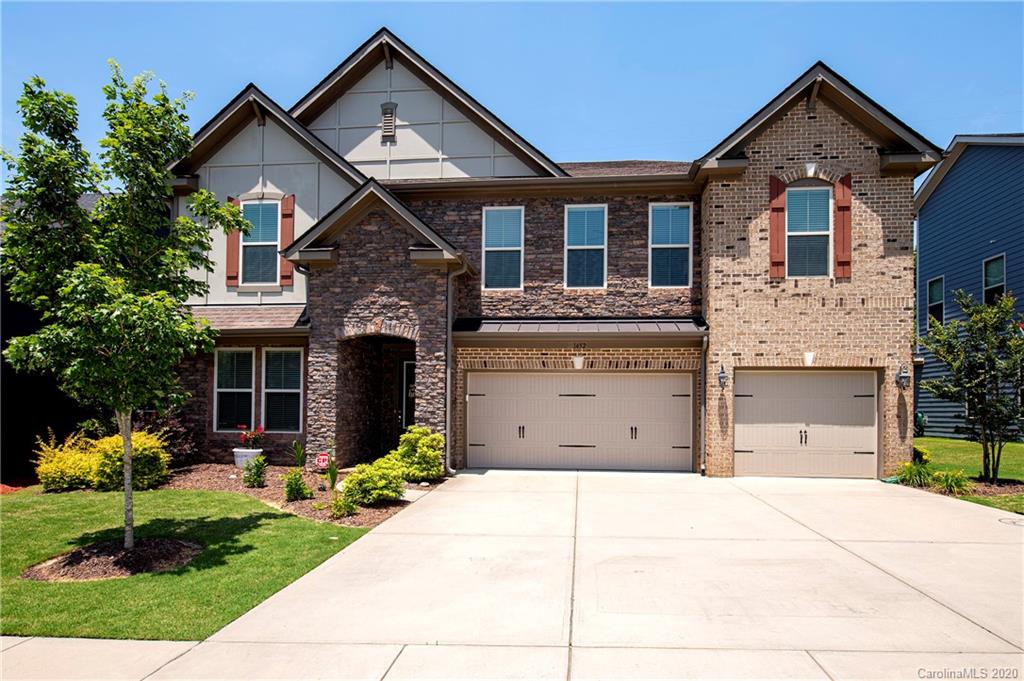 1452 Cilantro Court Tega Cay, SC 29708 - Photo 2 of 48 a front view of a house with a garden