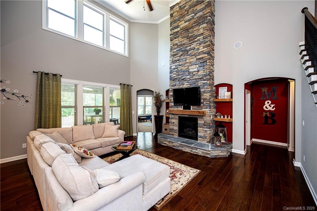 1452 Cilantro Court Tega Cay, SC 29708 - Photo 11 of 48 a living room with furniture a flat screen tv and a fireplace