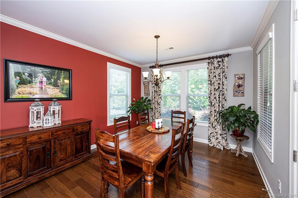 1452 Cilantro Court Tega Cay, SC 29708 - Photo 15 of 48 a view of a dining room with furniture window and wooden floor