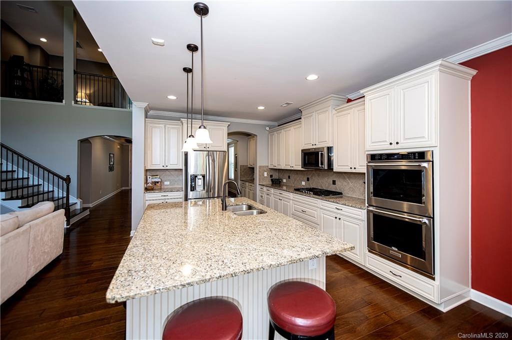 1452 Cilantro Court Tega Cay, SC 29708 - Photo 16 of 48 a kitchen with stainless steel appliances granite countertop a sink stove and refrigerator