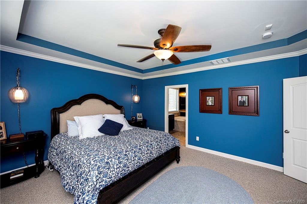 1452 Cilantro Court Tega Cay, SC 29708 - Photo 20 of 48 a bedroom with a bed and a potted plant
