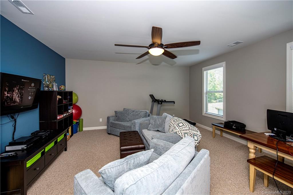1452 Cilantro Court Tega Cay, SC 29708 - Photo 26 of 48 a living room with furniture and a flat screen tv