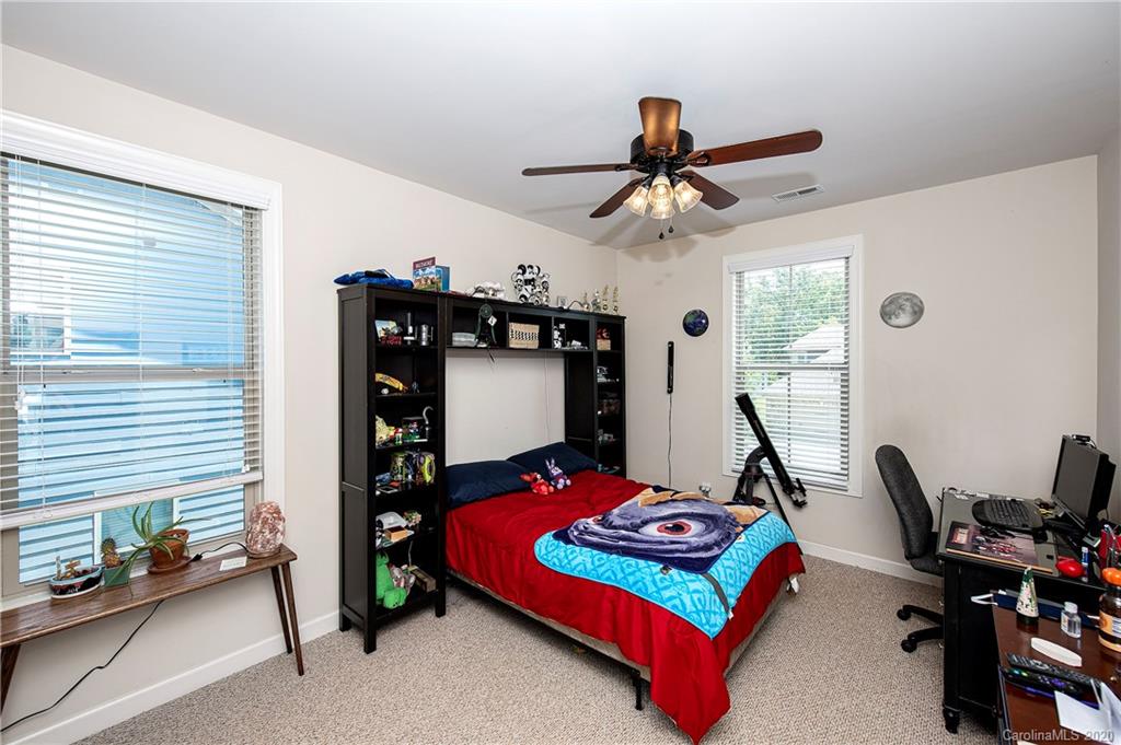 1452 Cilantro Court Tega Cay, SC 29708 - Photo 29 of 48 a bedroom with a bed and a window