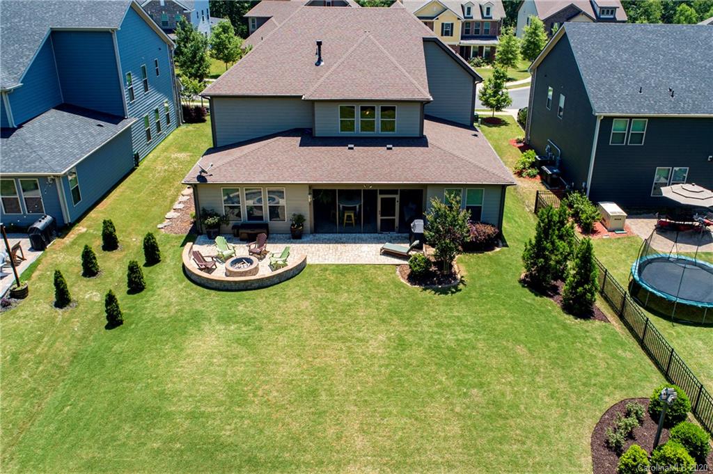 1452 Cilantro Court Tega Cay, SC 29708 - Photo 4 of 48 a view of a patio with table and chairs potted plants and a house