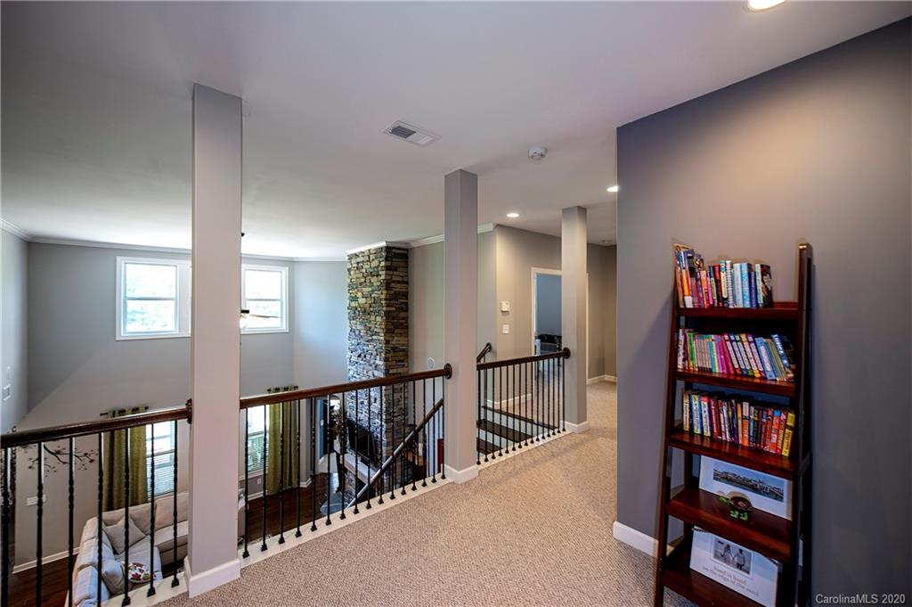 1452 Cilantro Court Tega Cay, SC 29708 - Photo 32 of 48 a view of a hallway with wooden floor and stairs