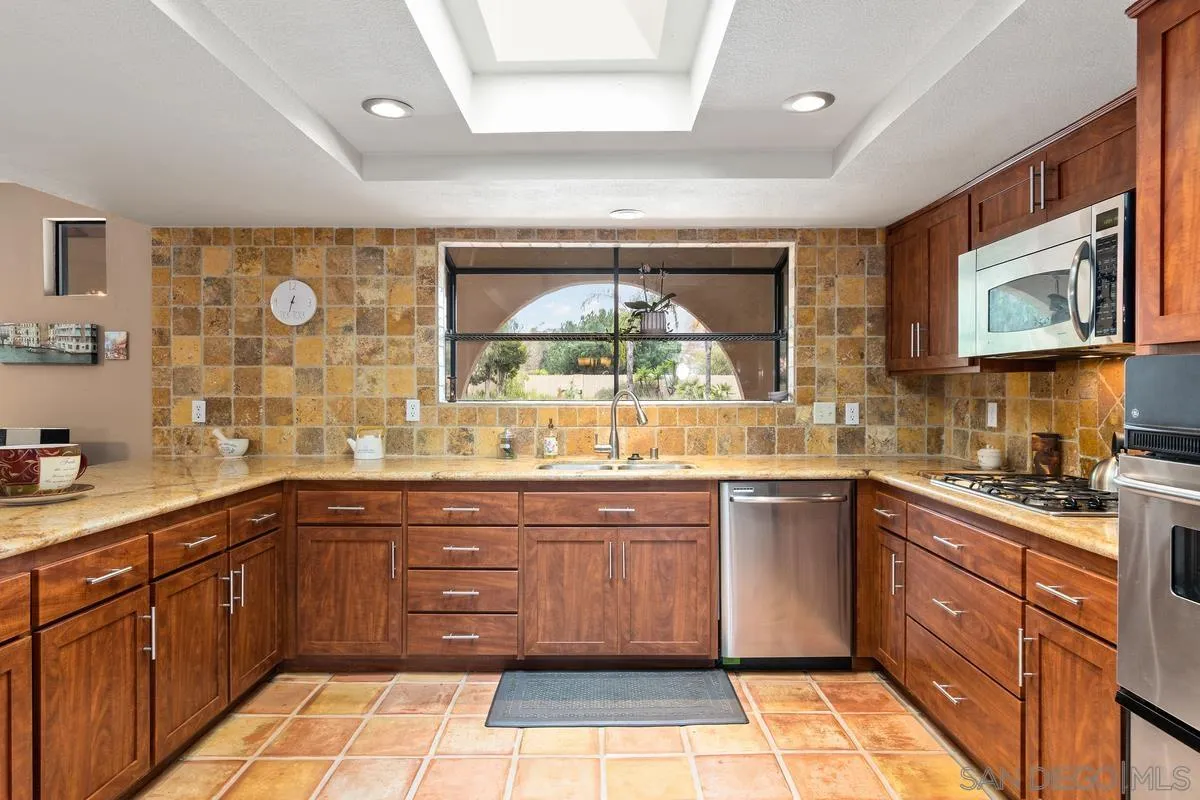 13767 Proctor Valley Road Jamul, CA 91935 - Photo 15 of 50 a kitchen with a sink cabinets and window