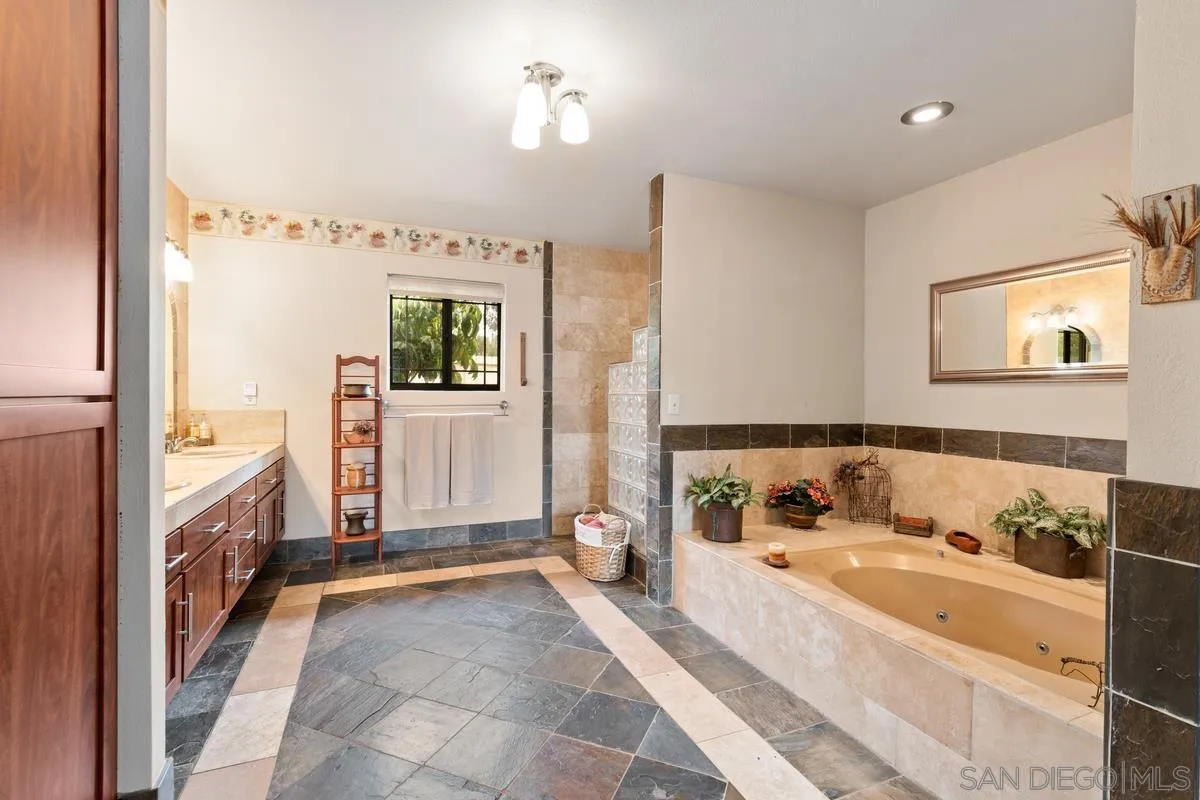 13767 Proctor Valley Road Jamul, CA 91935 - Photo 20 of 50 a bathroom with a tub sink and mirror