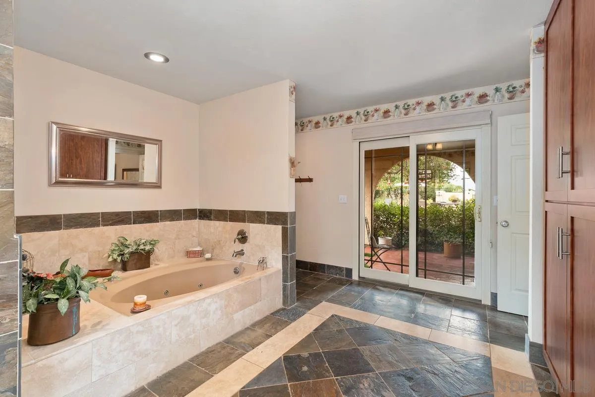 13767 Proctor Valley Road Jamul, CA 91935 - Photo 21 of 50 a bathroom with a bathtub and a shower