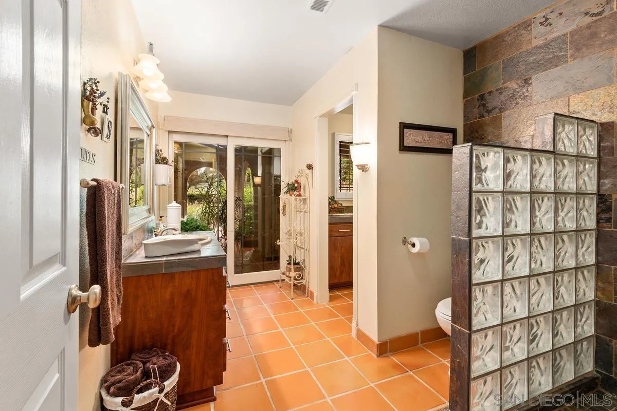 13767 Proctor Valley Road Jamul, CA 91935 - Photo 24 of 50 a bathroom with a tub shower and mirror