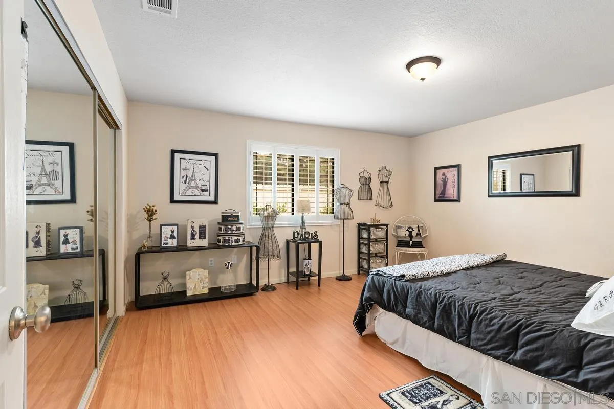 13767 Proctor Valley Road Jamul, CA 91935 - Photo 26 of 50 a bedroom with a large bed and a couch