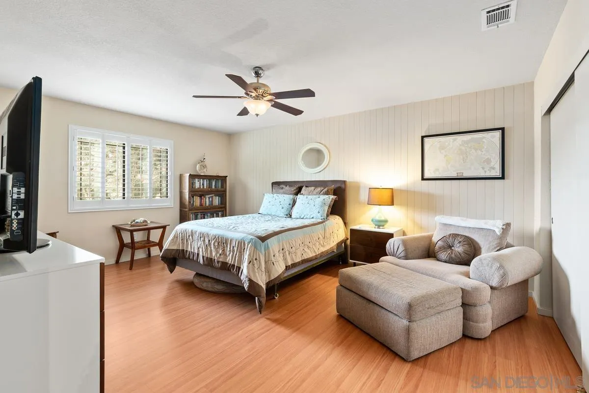 13767 Proctor Valley Road Jamul, CA 91935 - Photo 27 of 50 a bedroom with a bed wooden floor and window