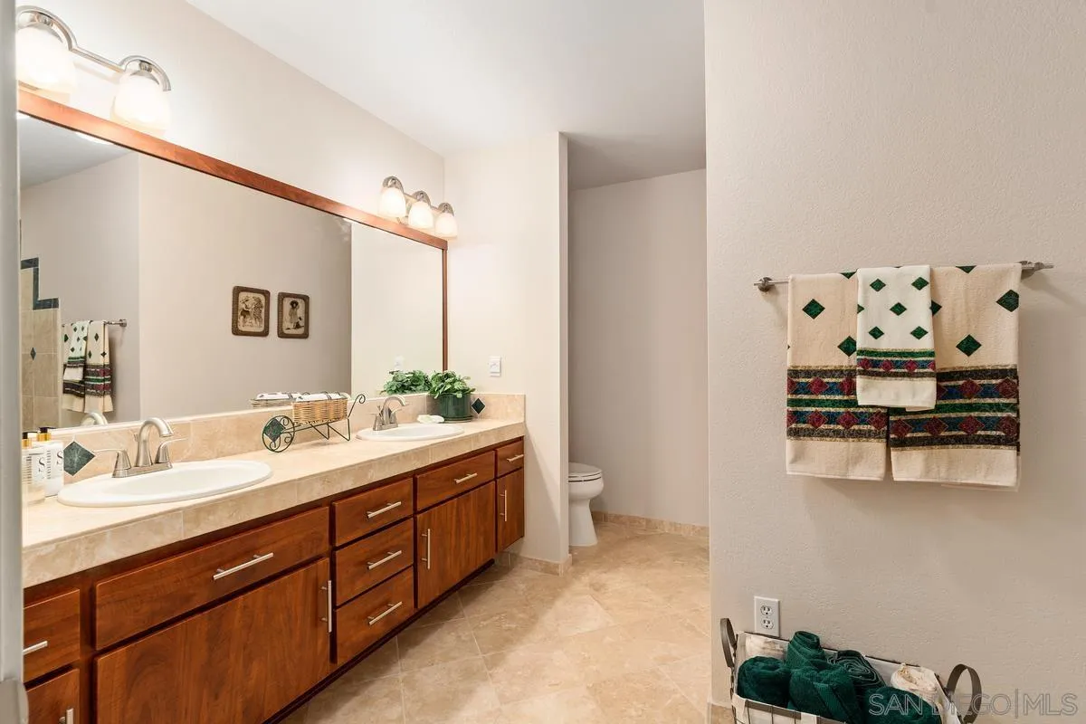 13767 Proctor Valley Road Jamul, CA 91935 - Photo 28 of 50 a bathroom with a double vanity sink mirror and