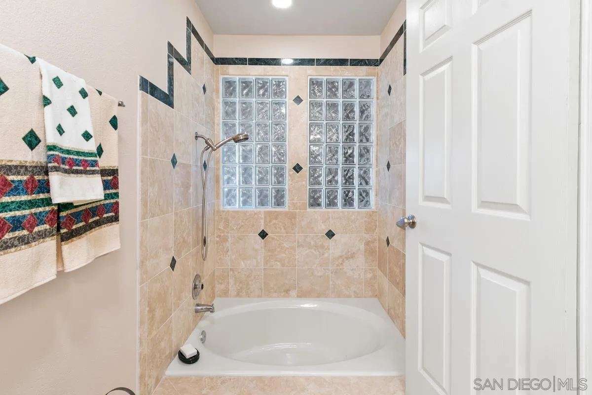 13767 Proctor Valley Road Jamul, CA 91935 - Photo 29 of 50 a bathroom with bathtub and shower