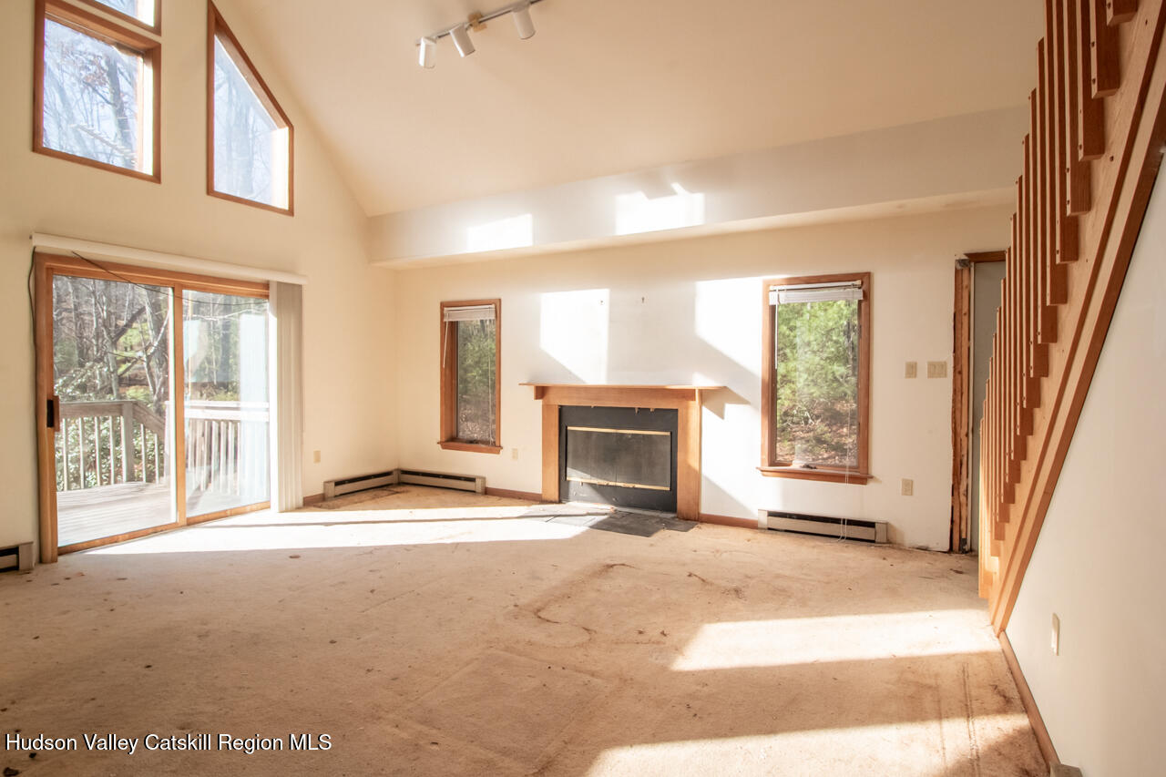 140 Stillerberg Strada Kerhonkson, NY 12446 - Photo 15 of 34 a view of an empty room with a fireplace and a window