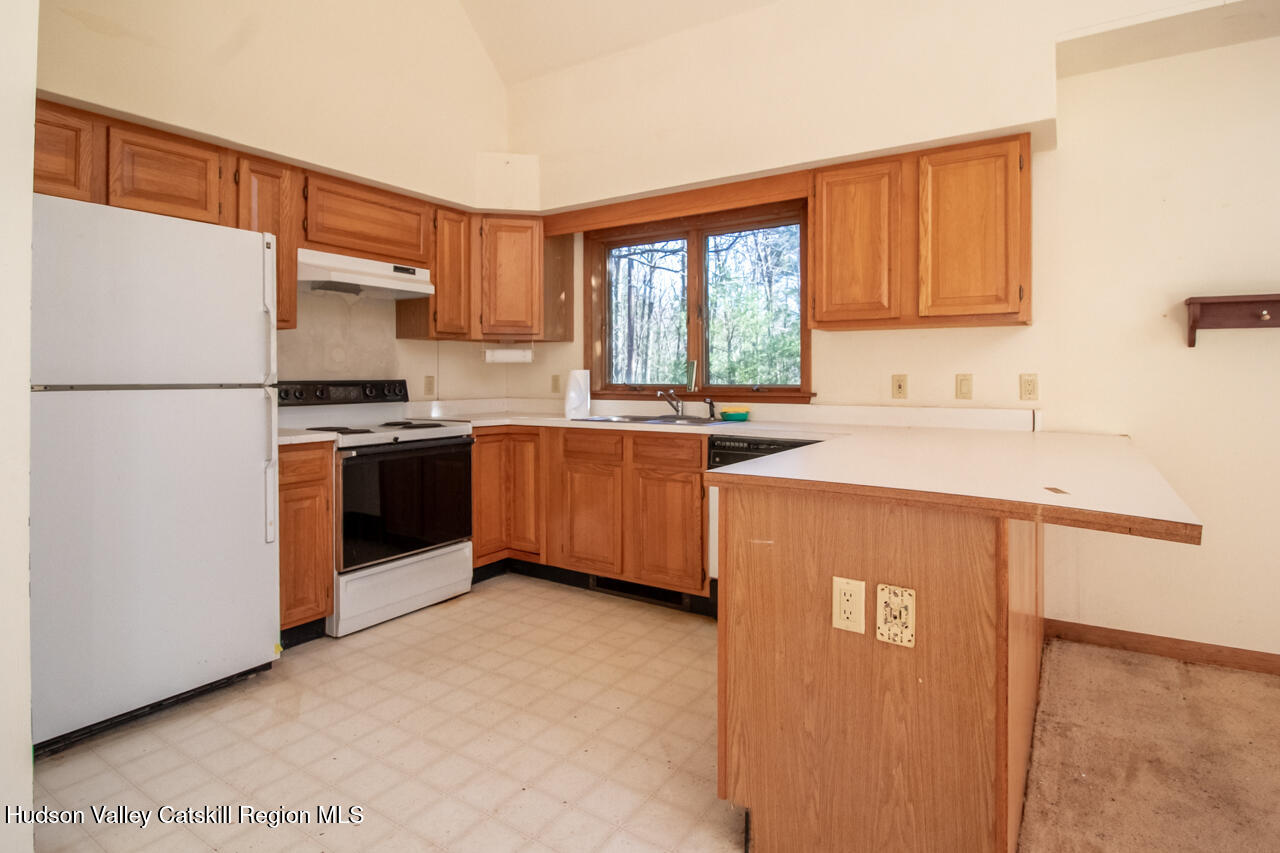 140 Stillerberg Strada Kerhonkson, NY 12446 - Photo 16 of 34 a kitchen with stainless steel appliances granite countertop a stove a sink dishwasher and a refrigerator