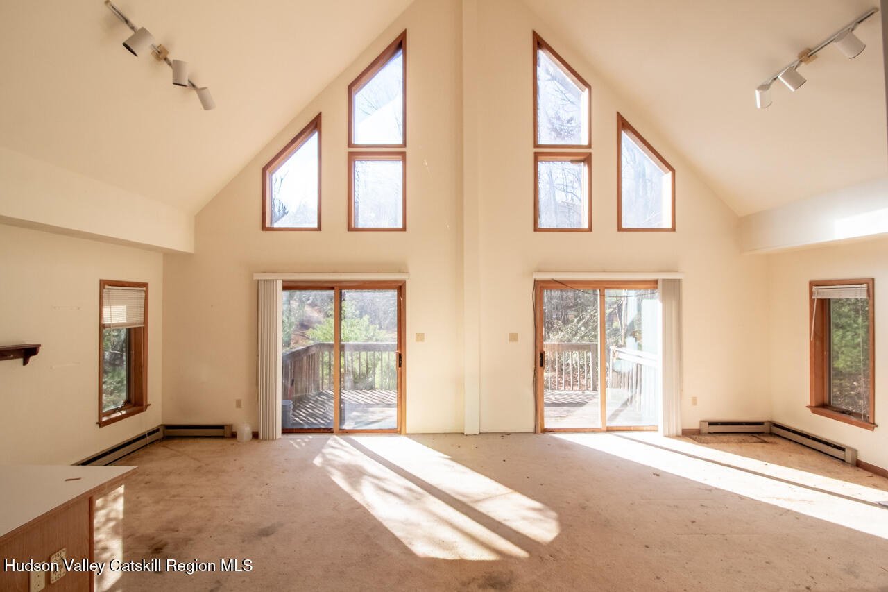 140 Stillerberg Strada Kerhonkson, NY 12446 - Photo 18 of 34 a view of an empty room with large windows