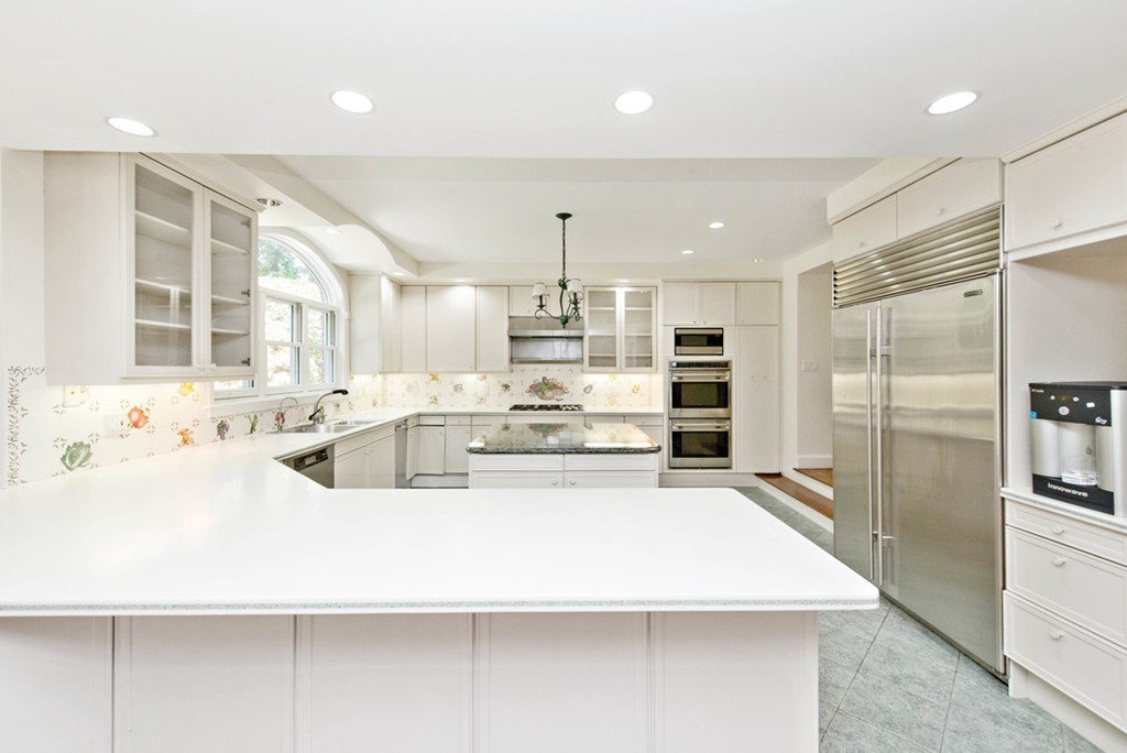 142 Neshobe Road Newton, MA 02468 - Photo 17 of 29 a kitchen with kitchen island a sink stainless steel appliances and cabinets
