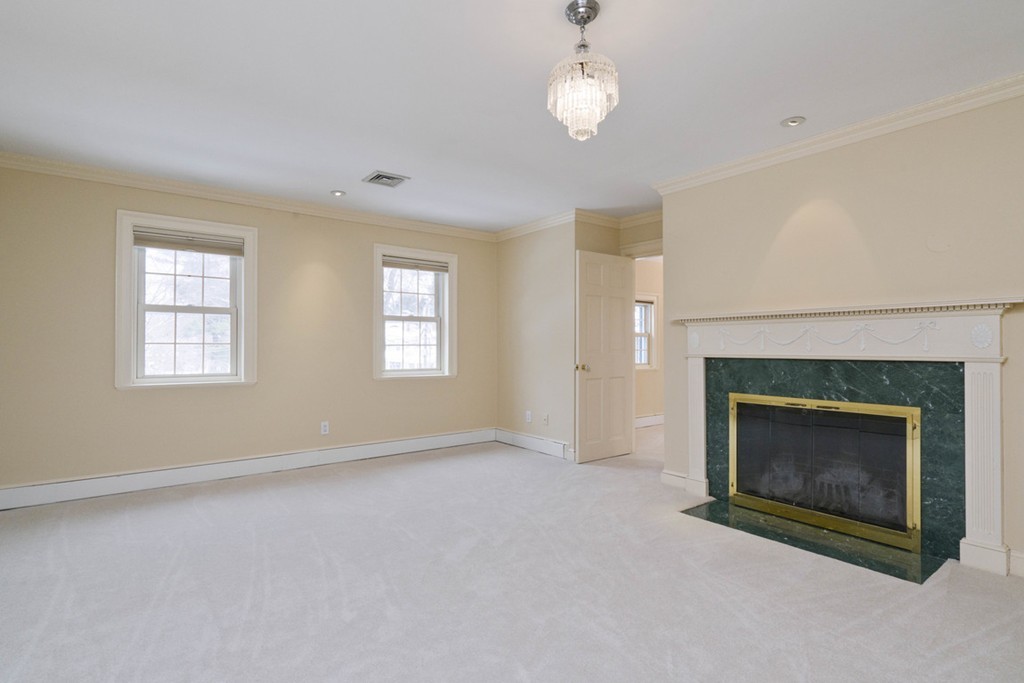 142 Neshobe Road Newton, MA 02468 - Photo 23 of 29 an empty room with windows and fireplace
