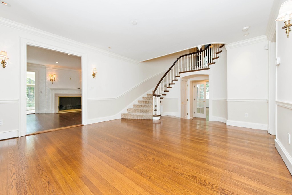 142 Neshobe Road Newton, MA 02468 - Photo 8 of 29 a view of empty room with wooden floor and stairs