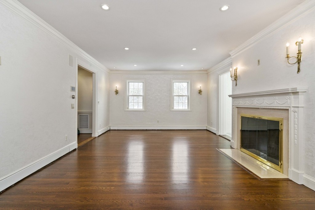 142 Neshobe Road Newton, MA 02468 - Photo 9 of 29 a view of an empty room with wooden floor fireplace and a window