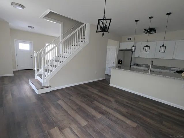 a view of a kitchen counter space with wooden floor
