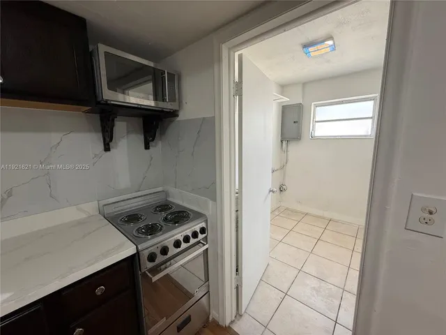 a kitchen with a stove and a microwave