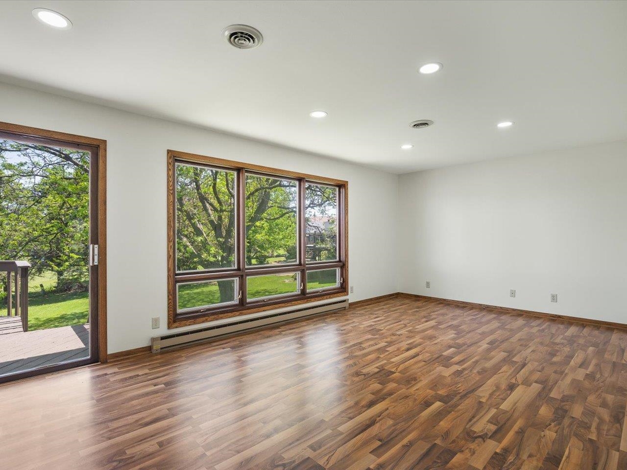 136 Lake Summerset Road Lake Summerset, IL 61019 - Photo 9 of 47 a view of an empty room with wooden floor and a window